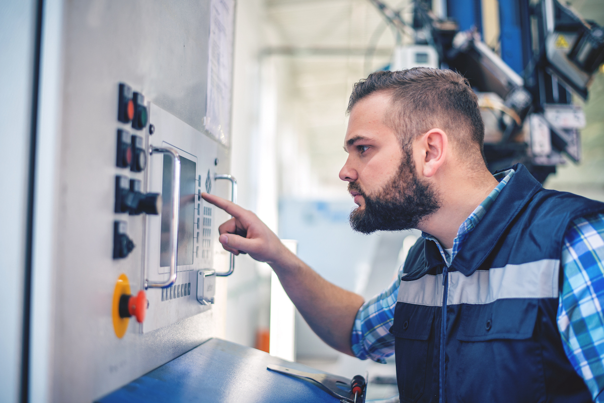 CNC machine adjustments by worker