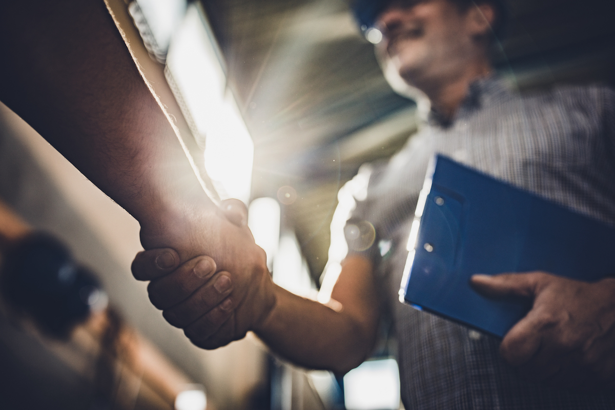 Industrial workers shaking hands.