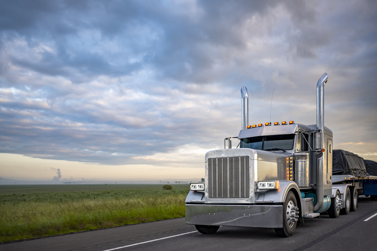 Semi-truck with a large load on a highway.