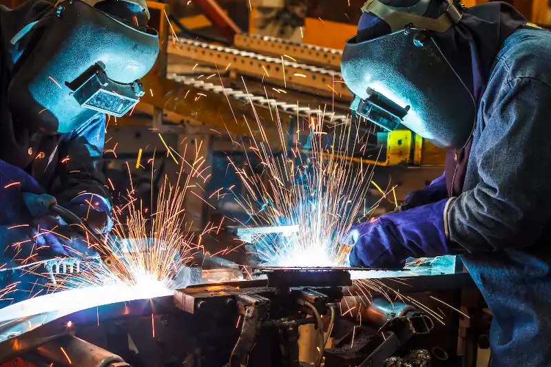 two welders working on a metal fabrication